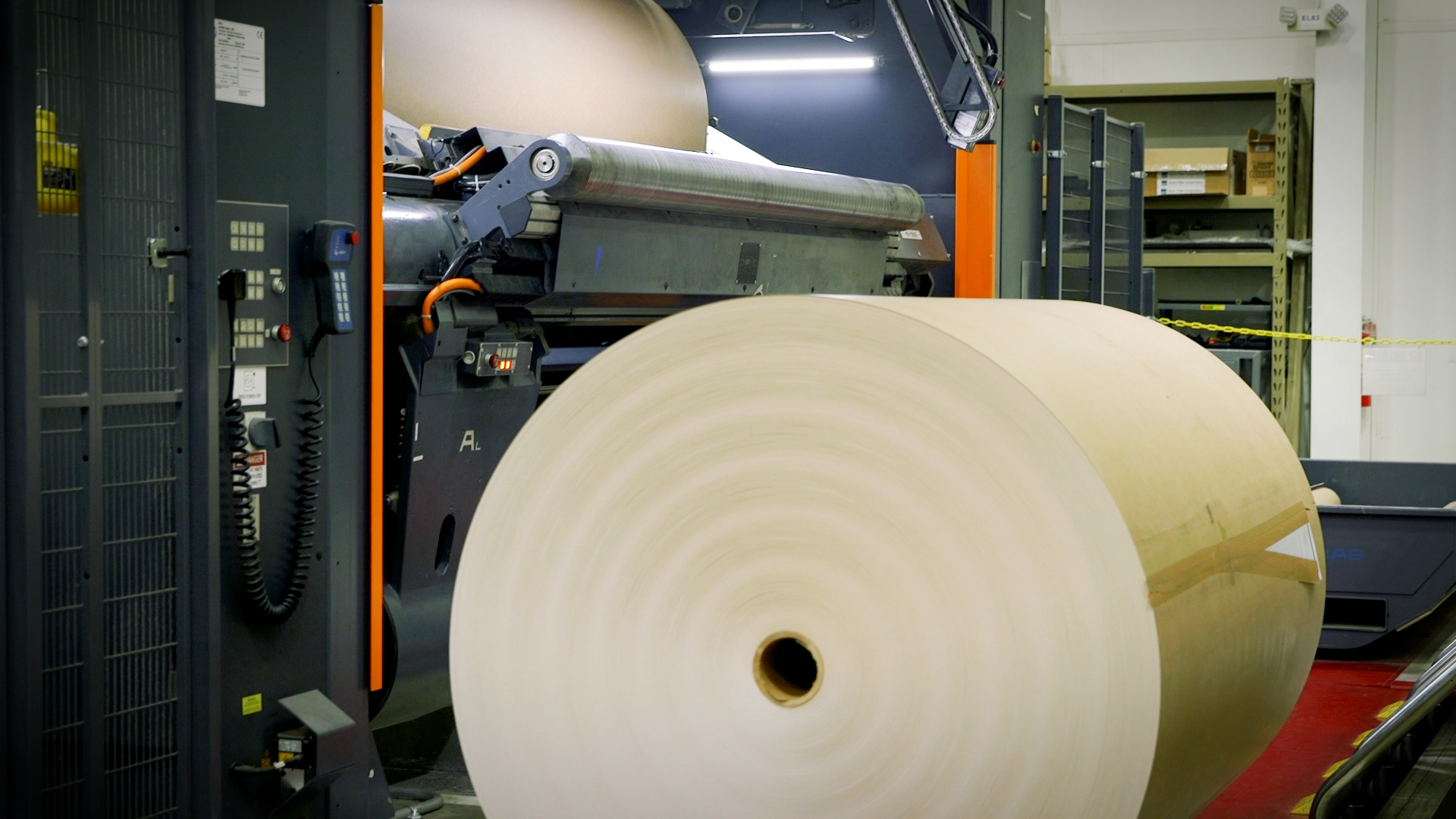 Roll of brown paper on a digital printing press.