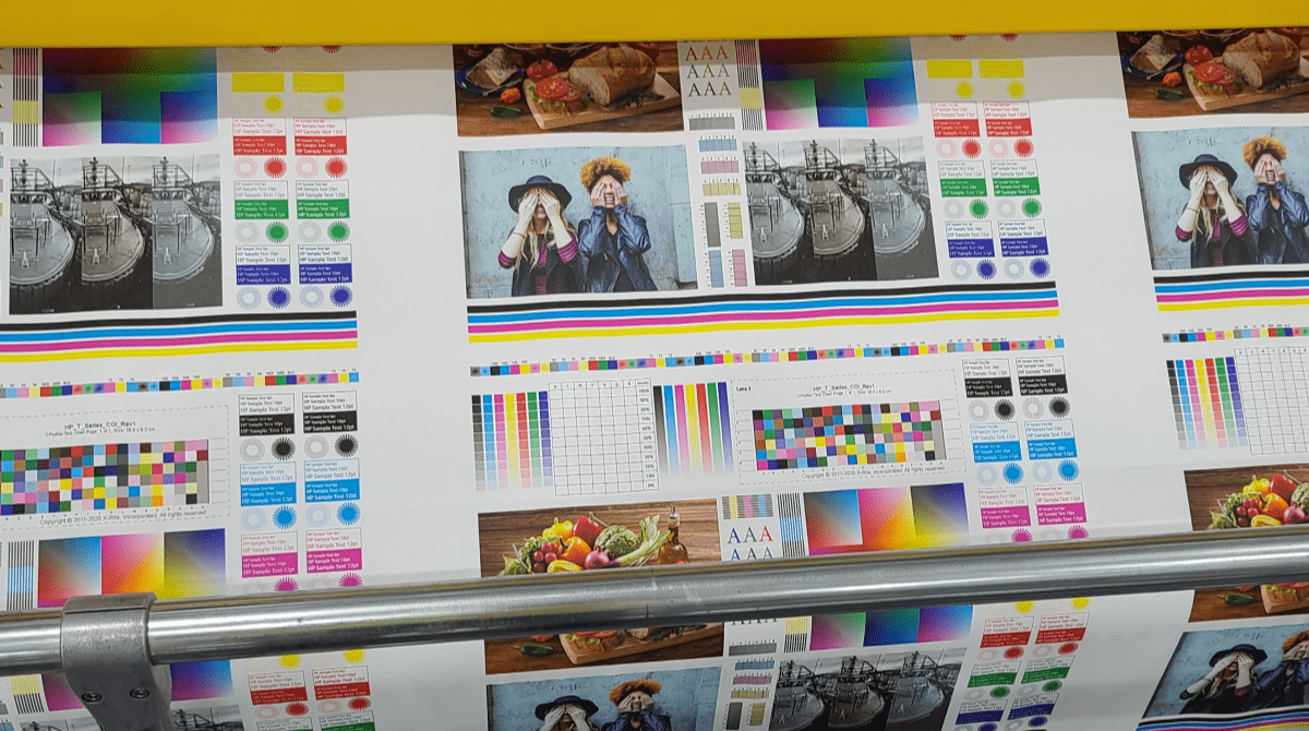 Graphic images on a printing press with CMYK color guides.